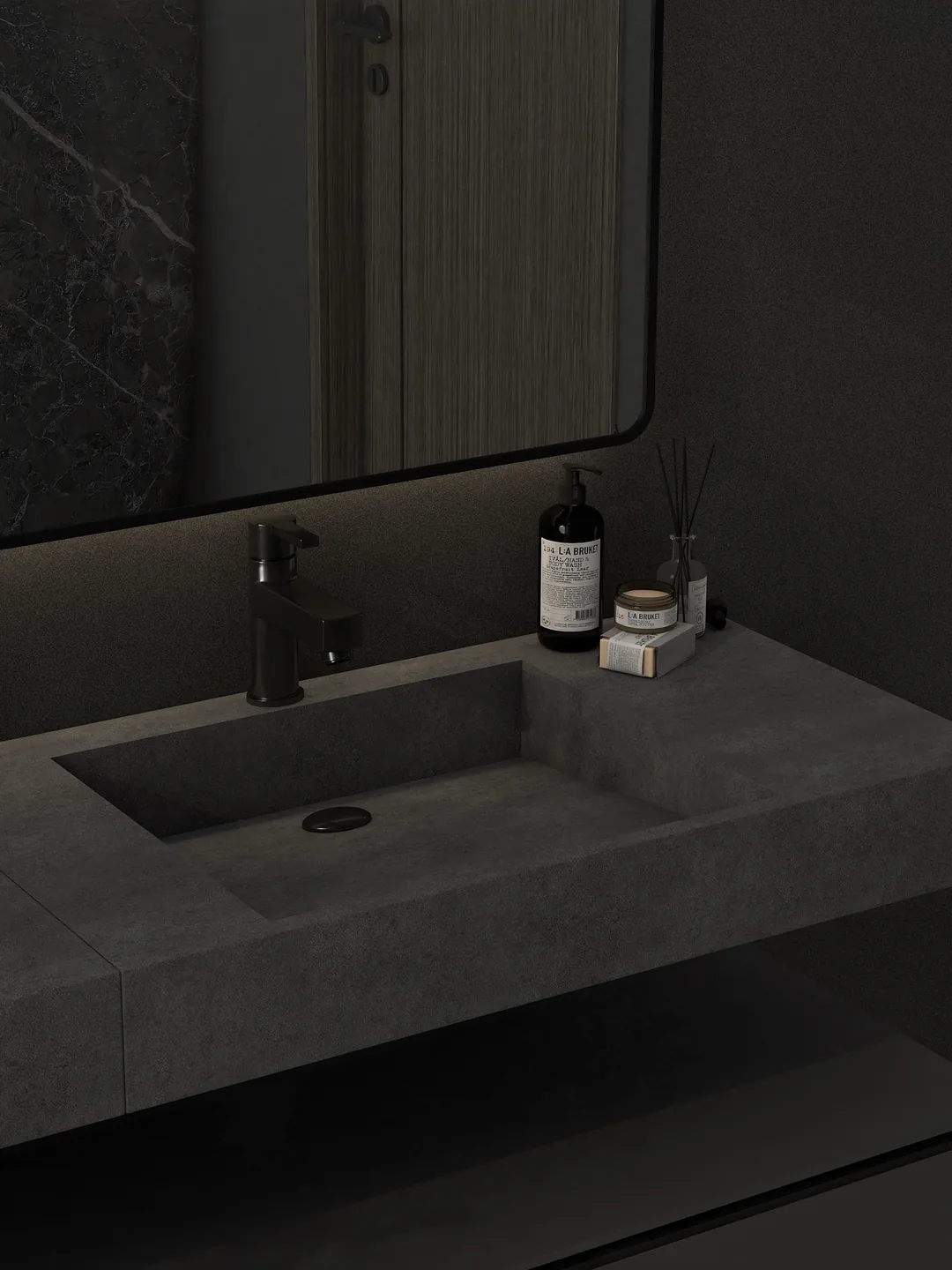 Rendu 3D d’une salle de bains sombre : vasque taillée dans la pierre grise, miroir à cadre noir, robinetterie noire.